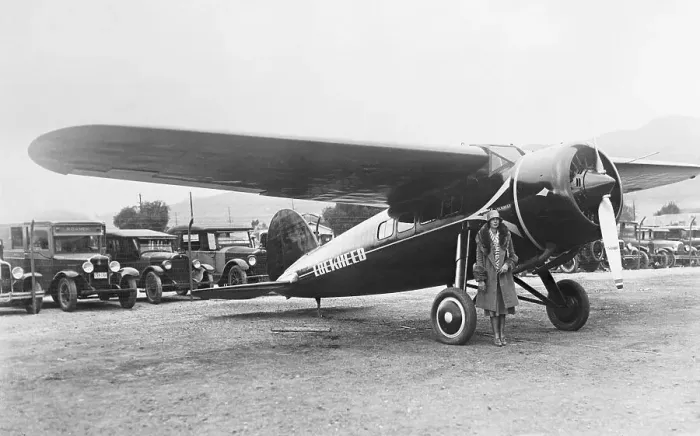 Framed Print : Amelia Earhart Posing Beside Plane Framed Print : Amelia Earhart Posing Beside Plane