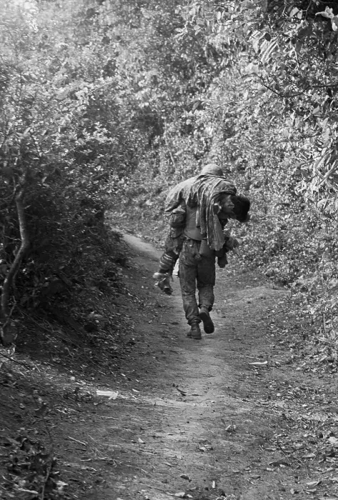 Framed Print : American Marine Carrying Wounded Buddy over Terrain