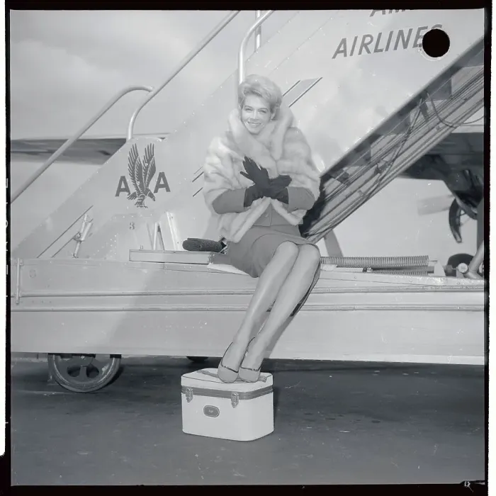 Framed Print : Angie Dickinson Sitting at Base of Airplane Steps