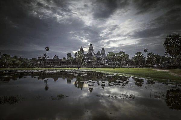 Angkor Wat temple at dawn reflected in water