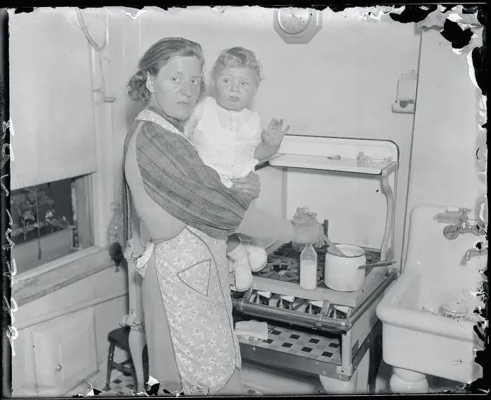 Framed Print : Anna Hauptmann Holding Baby at Stove Framed Print : Anna Hauptmann Holding Baby at Stove