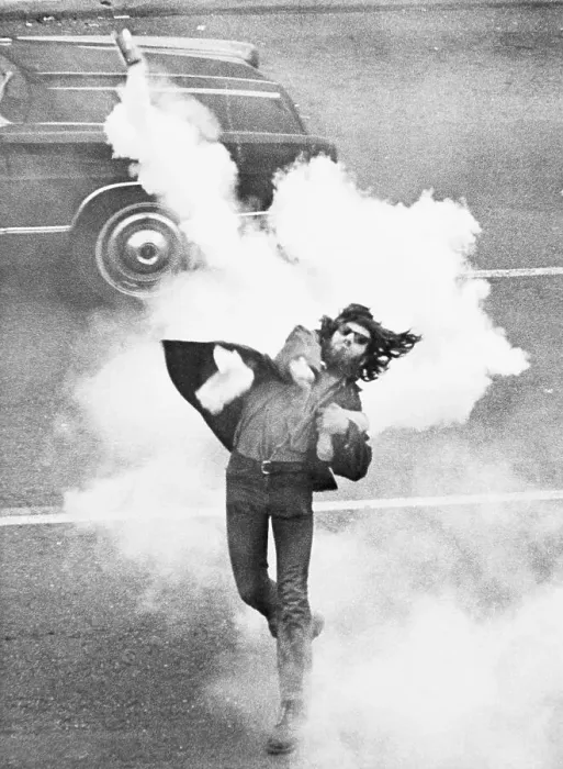 Framed Print : Anti-War Demonstrator Throwing Tear Gas