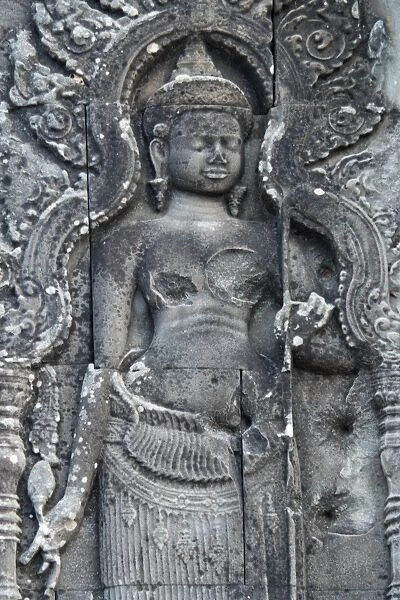Apsara stone craft damaged by ammo during war in the past at Phnom Bakheng famous place for sunset near angkor wat at siem reap, cambodia