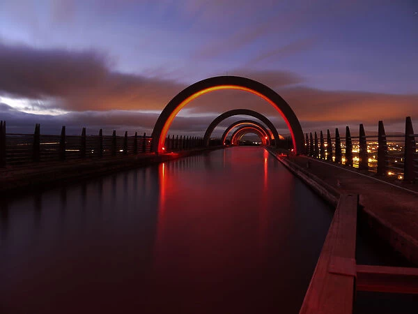 Arc structure. Night view of bridge with its light reflection on floor