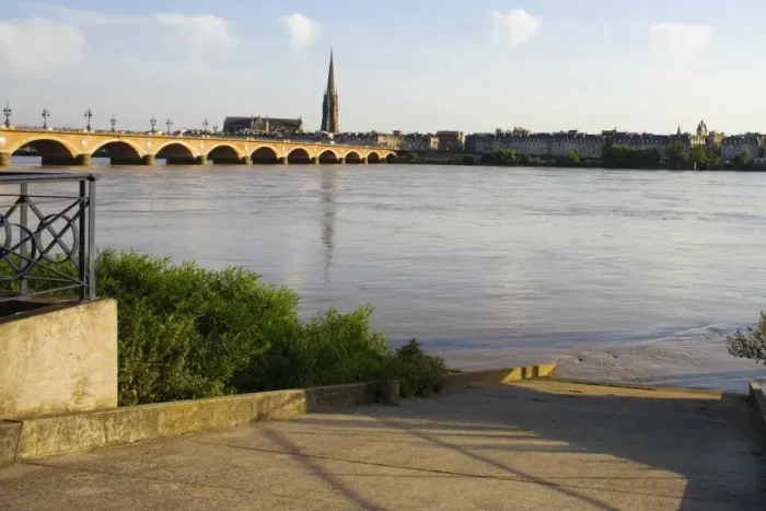 Framed Print : Arch bridge across a river, Pont De Pierre, St. Michel Basilica, Garonne River, Bordeaux, Aquitaine, France