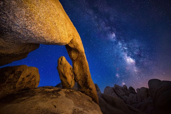 Arch rock at Joshua Tree national park with milky way
