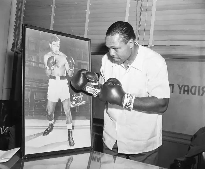 Framed Print : Archie Moore Punching at Picture of Rocky Marciano Framed Print : Archie Moore Punching at Picture of Rocky Marciano