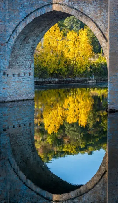 Framed Print : An archway of the Valentre Bridge in Cahors, France with the Lot River flowing underneath