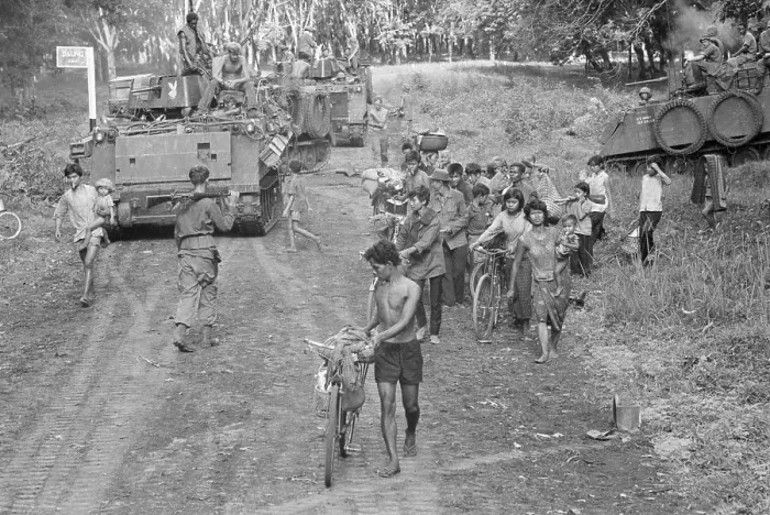 Framed Print : Army Tank & Group Of Cambodian Refugees Framed Print : Army Tank & Group Of Cambodian Refugees