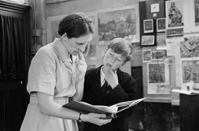 Framed Print : Art Class. A teacher and pupil looking over a portfolio in an art class Framed Print : Art Class. A teacher and pupil looking over a portfolio in an art class