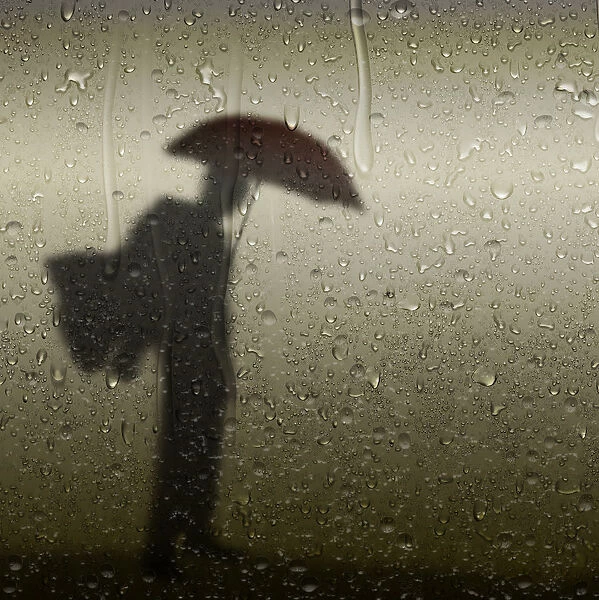 Artistic silhouette person with umbrella
