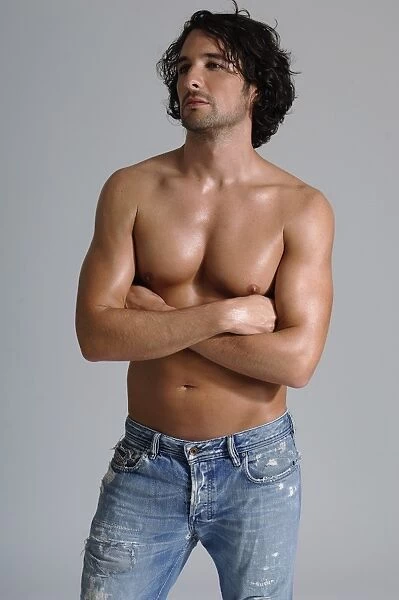 Athletic man, early 30s, bare-chested wearing jeans