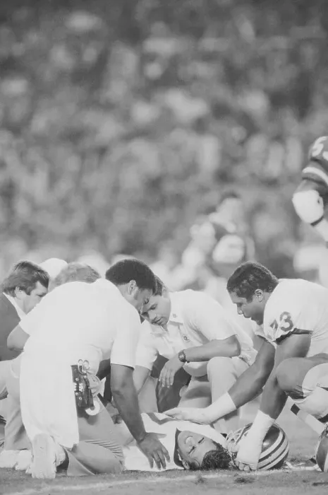 Framed Print : Athletic Trainers Surrounding Joe Theismann on Field Framed Print : Athletic Trainers Surrounding Joe Theismann on Field