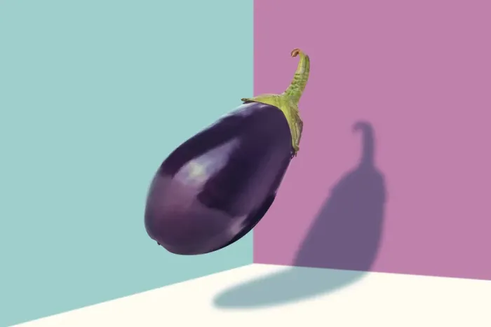 Framed Print : Aubergine at mid-air against a colored background