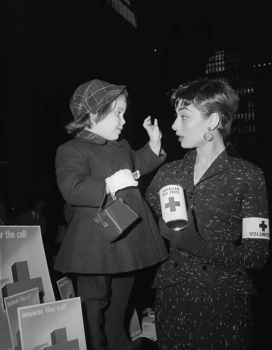 Framed Print : Audrey Hepburn Holding Red Cross Can and Talking With Young Girl Framed Print : Audrey Hepburn Holding Red Cross Can and Talking With Young Girl