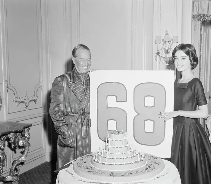 Framed Print : Audrey Hepburn Holding a Sign with Maurice Chevalier Framed Print : Audrey Hepburn Holding a Sign with Maurice Chevalier