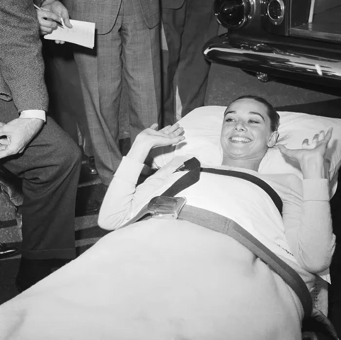 Framed Print : Audrey Hepburn Lying on a Stretcher Framed Print : Audrey Hepburn Lying on a Stretcher