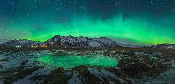 Aurora arch over a mountain range in Iceland