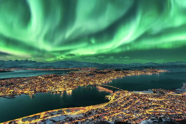 Aurora Borealis dancing over Tromso Urban Skyline, Northern Norway