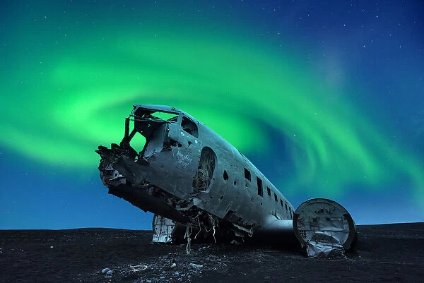 Aurora borealis over Douglas DC-3 Plane wreckage