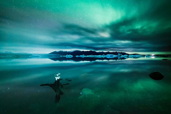 Aurora borealis (Northern lights) over glacial lagoon in Iceland