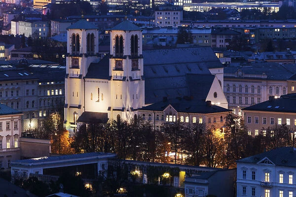 Austria, Salzburg, Illuminated St. Andrews Church and surrounding cityscape