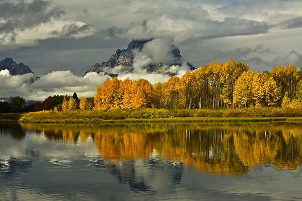 Autumn forest and Mount Moran reflecting in Oxbow Bend of Snake River at Grand Teton National Park, Wyoming, USA