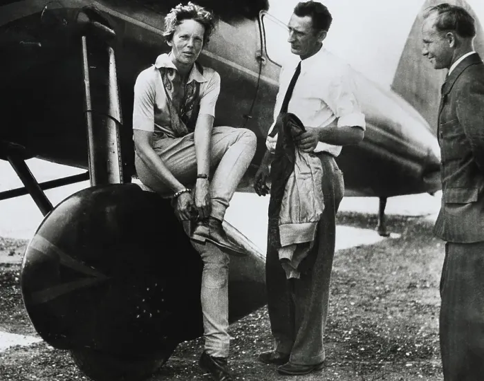 Framed Print : Aviatrix Amelia Earhart Adjusting Her Shoes After Successful Flight Framed Print : Aviatrix Amelia Earhart Adjusting Her Shoes After Successful Flight