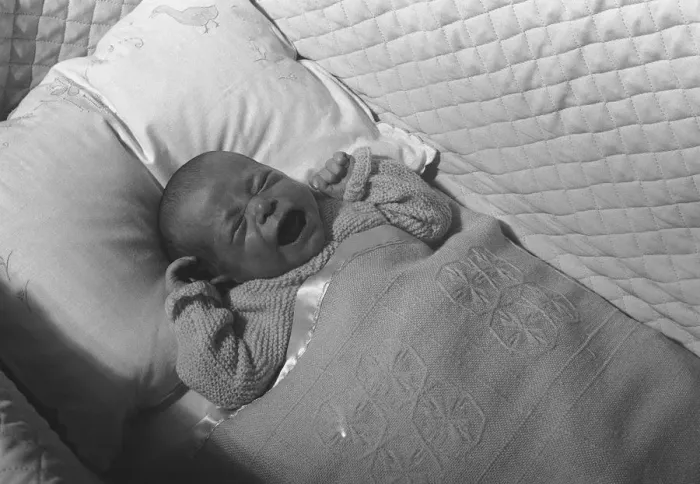 Framed Print : Baby (0-3 months) lying in crib, crying, (B&W), elevated view