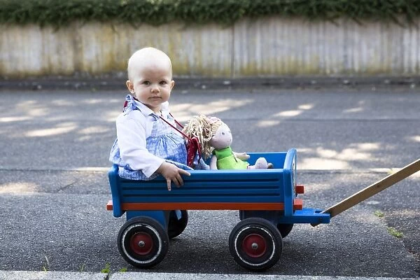 Baby, 12-14 months, sitting in a handcart