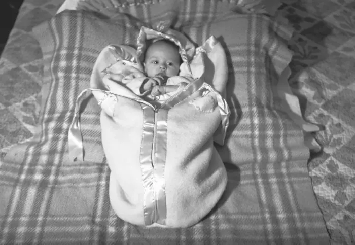 Framed Print : Baby (3-6 months) lying on blanket, (B&W), elevated view Framed Print : Baby (3-6 months) lying on blanket, (B&W), elevated view