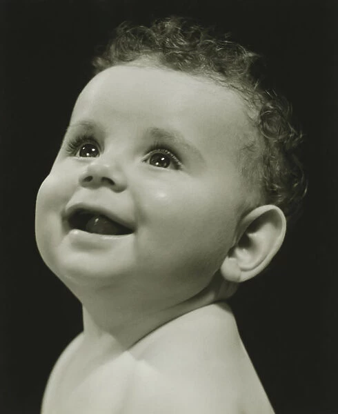 Baby (6-9 months) posing in studio, (B&W), portrait