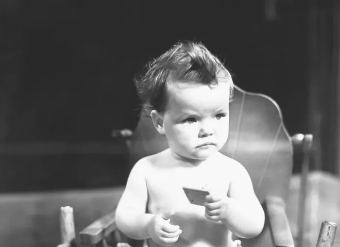 Framed Print : Baby (9-12 months) sitting in high chair, (B&W) Framed Print : Baby (9-12 months) sitting in high chair, (B&W)