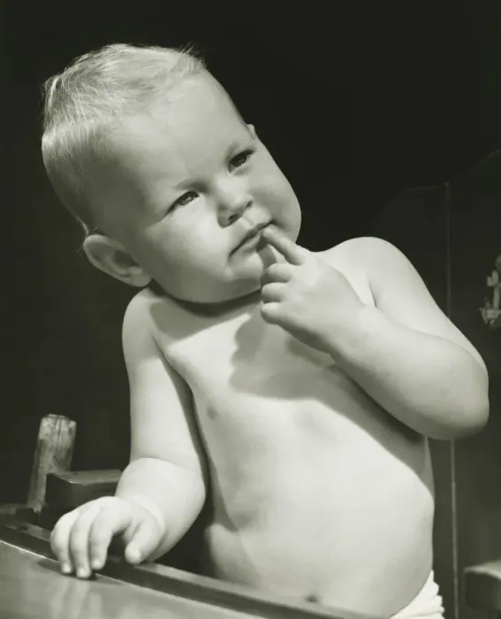 Framed Print : Baby boy (6-12 months) with finger on lips sitting in high chair, (B&W), portrait Framed Print : Baby boy (6-12 months) with finger on lips sitting in high chair, (B&W), portrait