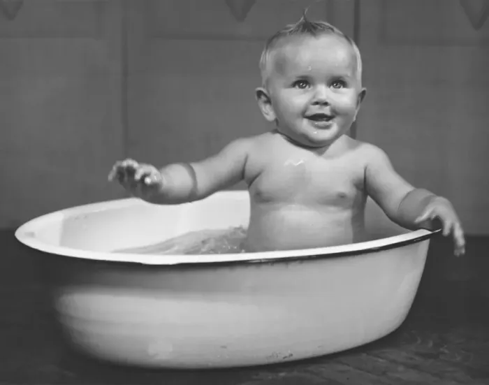 Framed Print : Baby boy (6-9 months) bathing in basin (B&W) Framed Print : Baby boy (6-9 months) bathing in basin (B&W)