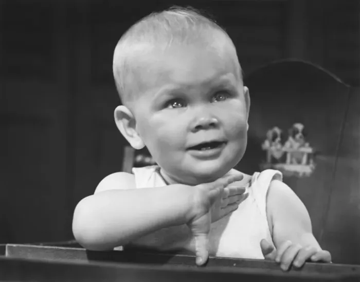 Framed Print : Baby boy (6-9 months) sitting in highchair (B&W)