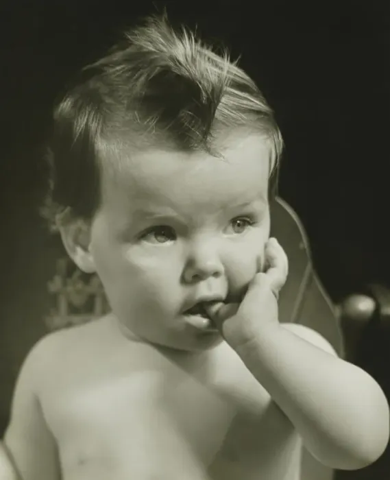 Framed Print : Baby boy (6-9 months) with thumb on mouth, (B&W), portrait