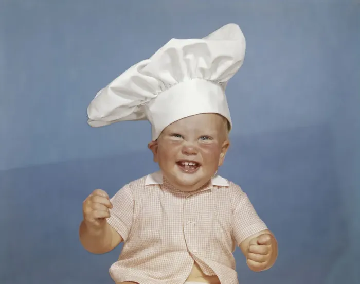 Framed Print : Baby boy wearing chefs hat, smiling, portrait Framed Print : Baby boy wearing chefs hat, smiling, portrait