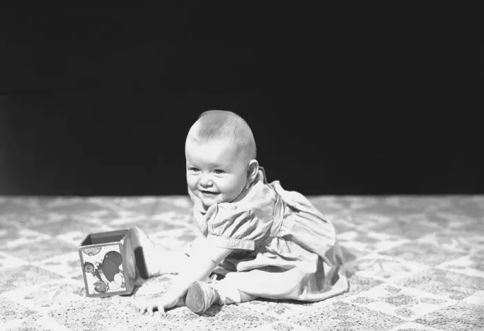 Framed Print : Baby girl (12-15 months) playing on blanket, (B&W)