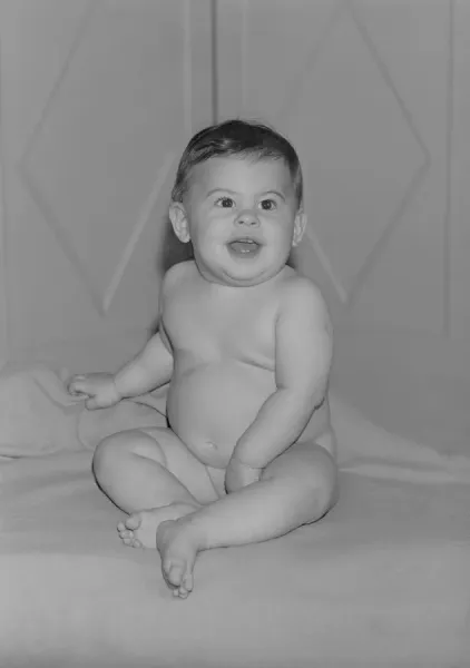 Baby Girl Sitting on Bed and Laughing Print Art