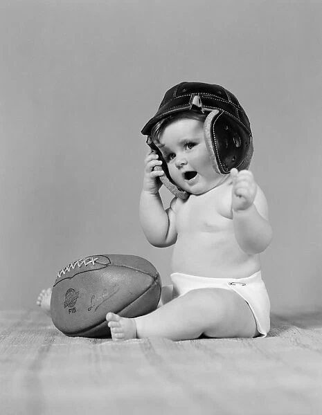 Baby girl wearing leather football helmet