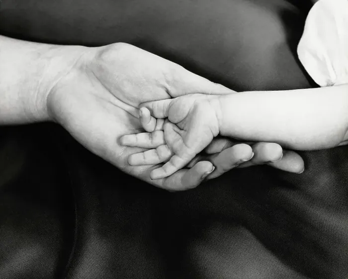 Framed Print : Baby girl's hand in mother's hand, close-up Framed Print : Baby girl's hand in mother's hand, close-up