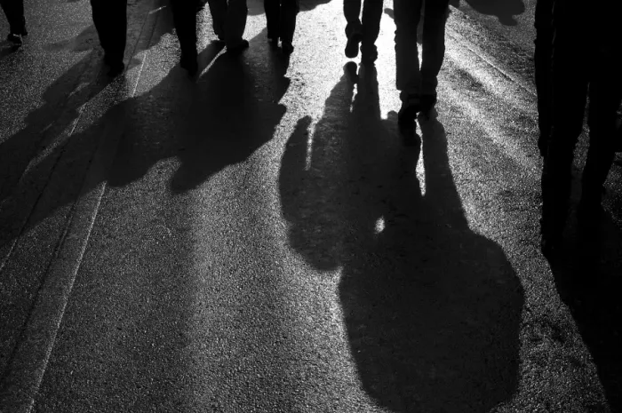 Framed Print : Backlit persons casting shadows on the asphalt Framed Print : Backlit persons casting shadows on the asphalt