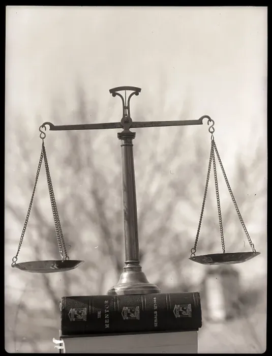 Framed Print : Balance Scales Perched On Book Framed Print : Balance Scales Perched On Book