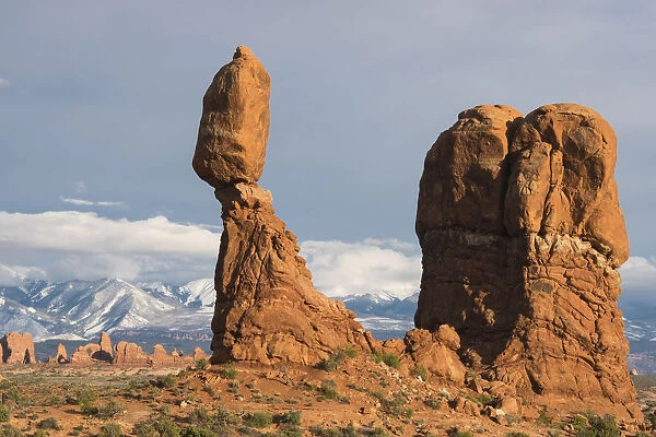 Balanced Rock in Arches National Park, with snow-covered La Sal mountains in background, Utah, USA