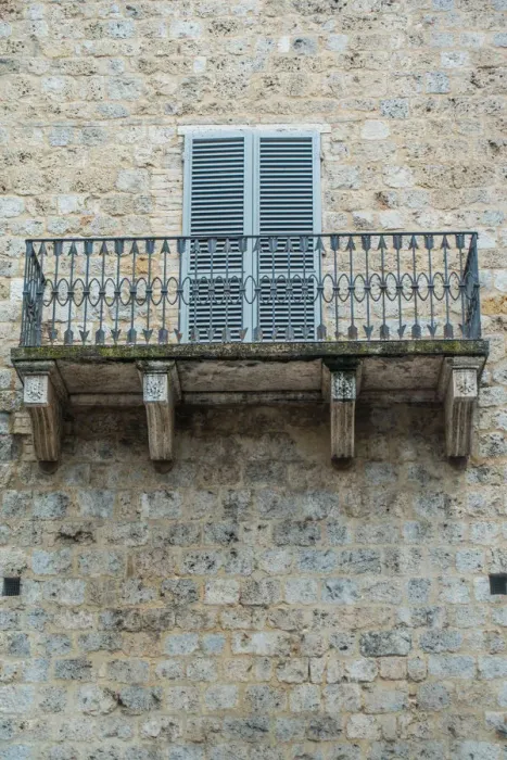 Framed Print : Balcony. Stone building and wrought iron balcony with pattern of arrows Framed Print : Balcony. Stone building and wrought iron balcony with pattern of arrows