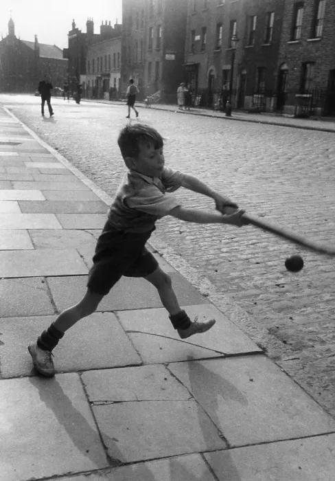 Framed Print : Ball Game. 7th August 1954: A young boy playing an improvised game of cricket with a bat Framed Print : Ball Game. 7th August 1954: A young boy playing an improvised game of cricket with a bat