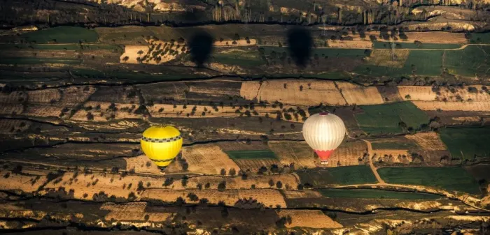 Framed Print : Two balloons floating over Cappadocia landscape Framed Print : Two balloons floating over Cappadocia landscape