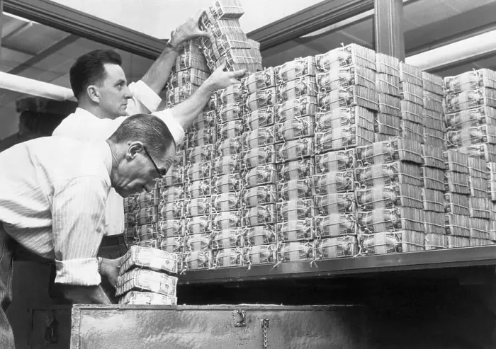 Framed Print : Bank Tellers Piling Stacks of US Dollars Framed Print : Bank Tellers Piling Stacks of US Dollars