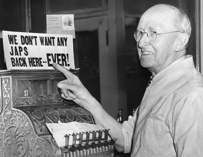 Framed Print : Barber Points to Anti-Japanese Sign Framed Print : Barber Points to Anti-Japanese Sign